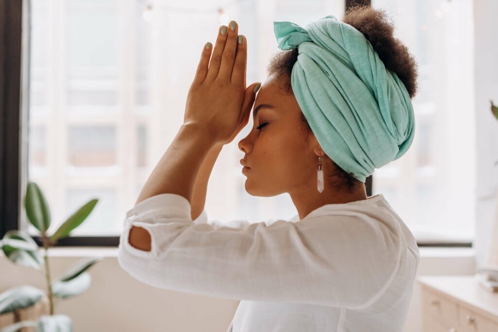 reiki practitioner in reiki prayer pose before healing session